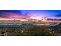 Expansive city views from a luxurious home, showcasing vibrant sunset and mountain views at 42237 N 107Th Pl, Scottsdale, AZ 85262