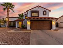 Charming two-story home with a red tile roof, two car garage, and a low maintenance desert landscape at 5761 E Tierra Buena Ln, Scottsdale, AZ 85254