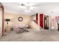 Spacious living room with plush carpet, neutral walls, and a staircase in view at 5808 E Brown Rd # 110, Mesa, AZ 85205