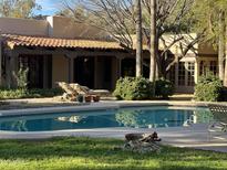 Relaxing backyard pool area with lounge chairs and a view of the home's architecture at 6242 E Maverick Rd, Paradise Valley, AZ 85253