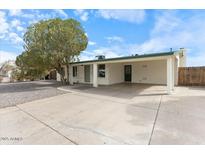 Charming single-story home with a spacious covered parking area and mature landscaping at 739 E Glade Ave, Mesa, AZ 85204