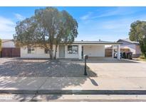 Charming single-story home with carport, xeriscaped front yard, and beautiful shade tree at 739 E Glade Ave, Mesa, AZ 85204