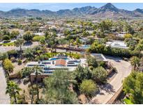 Expansive property featuring a pool and lush landscaping with views of the surrounding city and mountains at 8008 N 66Th St, Paradise Valley, AZ 85253