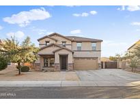 Charming two-story home with desert landscaping, covered entry, and a two car garage at 925 E Doris St, Avondale, AZ 85323