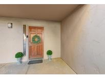 Inviting front door featuring a wreath and potted plants adding charm and curb appeal to the entrance at 9460 N 92Nd St # 119, Scottsdale, AZ 85258