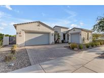 Charming single-story home featuring a three-car garage, desert landscaping, and a neutral-toned stucco exterior at 10455 E Thornton Ave, Mesa, AZ 85212