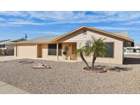 Charming single-story home featuring a desert landscape, attached garage, and well-maintained facade at 10620 W Snead Dr, Sun City, AZ 85351