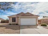 Charming single-story home features a large garage, low-maintenance landscaping, and a tile roof at 1165 W 4Th Ave, Apache Junction, AZ 85120