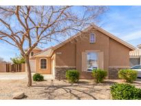 Charming single-Gathering home featuring a low maintenance desert landscape, quaint architectural details, and a cozy design at 12312 N 147Th Ln, Surprise, AZ 85379