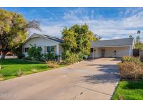 Charming single-story home with a spacious driveway, mature landscaping, and a well-maintained front yard at 2125 W Berridge Ln, Phoenix, AZ 85015