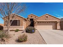 Charming single-story home featuring a two-car garage, desert landscaping, and secure front entry at 29247 N Bauxite Ln, San Tan Valley, AZ 85143