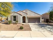 Charming single-story home with a two-car garage, desert landscaping, and a tile roof in a quiet neighborhood at 3781 S Pablo Pass Dr, Gilbert, AZ 85297