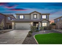 Charming two-story home with a well-manicured lawn and attached two-car garage at 43819 W Wolf Dr, Maricopa, AZ 85138