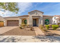 Charming single-story home featuring a tiled roof, attached garage and desert landscaping at 4684 N 206Th Ave, Buckeye, AZ 85396