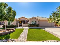 Charming home featuring desert landscaping and artificial turf for low maintenance beauty at 6543 E Preston St, Mesa, AZ 85215