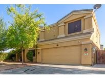 Two-story stucco home with a two-car garage and mature landscaping, offering curb appeal at 8305 W Pioneer St, Tolleson, AZ 85353