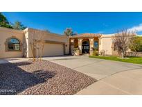 Beautiful single-story home with a well-manicured lawn, desert landscaping, and a spacious driveway at 9214 N 83Rd St, Scottsdale, AZ 85258