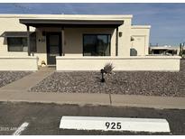 Charming single-story home featuring neutral stucco and a covered front entrance in a well-maintained community at 925 E Lancaster Cir, Florence, AZ 85132