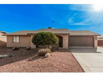 Single level home showcasing desert landscaping, a two car garage, and a front entrance with gate at 9283 W Rafael Dr, Arizona City, AZ 85123