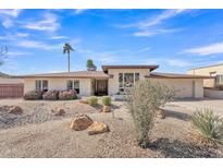 Inviting single-story home with desert landscaping, mature trees, and neutral color palette at 9410 N 18Th St, Phoenix, AZ 85020