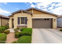 Charming single-story home featuring a two-car garage, stone accents, and manicured landscaping at 9610 E Trent Ave, Mesa, AZ 85212