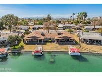 Aerial view of the home and surrounding neighborhood along a waterway at 10116 W Bolivar Dr, Sun City, AZ 85351