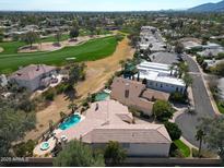 Expansive aerial view of a luxury home with a pool, golf course access, and desert landscaping at 10125 N 78Th Pl, Scottsdale, AZ 85258
