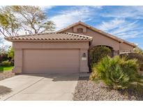 Charming single-story home with a tile roof, desert landscaping and a two car garage at 1117 W Davis Rd, Phoenix, AZ 85023