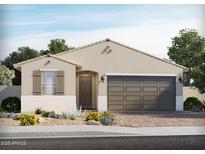 Charming single-story home featuring a neutral stucco exterior, a two-car garage and professionally landscaped front yard at 122 N 176Th Ln, Goodyear, AZ 85338