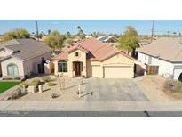 Charming single-story home featuring a well-maintained front yard and a two-car garage at 14720 W Edgemont Ave, Goodyear, AZ 85395
