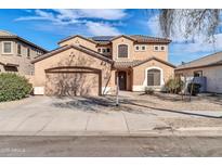 Charming two-story stucco home featuring a two-car garage and low maintenance landscaping at 17388 W Elaine Dr, Goodyear, AZ 85338