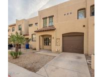 Charming townhouse featuring an attached garage and desert landscaping for low maintenance appeal at 1930 E Hayden Ln # 111, Tempe, AZ 85281