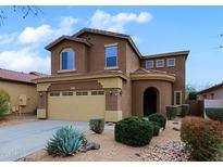 Two-story home with neutral stucco, arched entry, desert landscaping, and a two-car garage at 2527 W Amber Sun Dr, Phoenix, AZ 85085