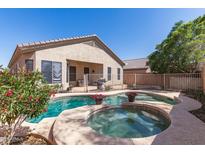 Inviting backyard pool and spa area perfect for relaxation and entertaining, surrounded by lush landscaping at 26826 N 66Th Ln, Phoenix, AZ 85083