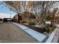 Stunning modern home featuring unique architectural design, desert landscaping, and a gravel driveway at 37 E Foothill Dr, Phoenix, AZ 85020