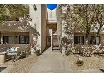 Exterior view of the condo featuring a walkway and stairs leading to upper levels at 4850 E Desert Cove Ave # 251, Scottsdale, AZ 85254