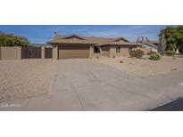 Charming single-story home featuring a two car garage and low maintenance desert landscaping at 6010 E Greenway Ln, Scottsdale, AZ 85254
