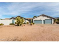 Charming single-story home featuring a three-car garage, desert landscaping and beautiful desert views at 6404 S Lazy Ln, Gold Canyon, AZ 85118