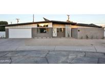 Charming ranch-style home featuring desert landscaping, modern brickwork, and a spacious two-car garage at 802 E Campus Dr, Tempe, AZ 85282