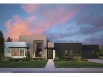 Contemporary home showcasing a striking facade, manicured lawn, and modern design elements at dusk at 86Xx E Stagecoach Pass # 4, Carefree, AZ 85377