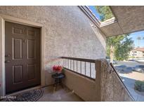 Front door entrance to unit with a small table and flower arrangement at 9460 E Mission Ln # 203, Scottsdale, AZ 85258