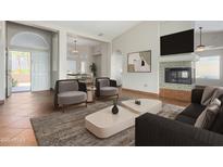 Bright living room featuring stylish furniture, fireplace, and an open floor plan at 16629 E Westby Dr, Fountain Hills, AZ 85268