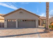 Spacious three-car garage with a decorative brick driveway and well-maintained exterior at 24413 S Lakeway Sw Cir, Sun Lakes, AZ 85248