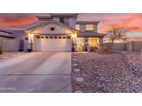 Charming two-story home with a well-manicured yard, two-car garage, and inviting front porch at 29576 N Gecko Trl, San Tan Valley, AZ 85143