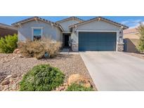 Charming single-story home with desert landscaping and a two-car garage at 34074 N Beeblossom Trl, San Tan Valley, AZ 85144