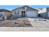 Charming single-story home featuring stone accents, a two-car garage, and desert landscaping at 4083 W Eli Dr, San Tan Valley, AZ 85144