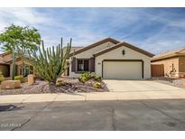 Charming home showcasing desert landscaping and an attached two-car garage at 41012 N Noble Hawk Way, Anthem, AZ 85086