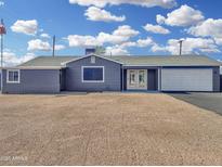 Charming single-story home with a gravel yard, white garage door, and inviting double-door entrance at 776 S Saguaro Dr, Apache Junction, AZ 85120