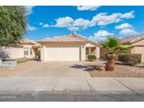 Charming single-story home with a well-maintained front yard and two-car garage at 10814 W Alvarado Rd, Avondale, AZ 85392