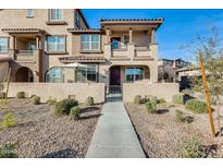 Inviting two-story townhome featuring a private gated front patio and desert landscaping at 1255 N Arizona Ave # 1093, Chandler, AZ 85225
